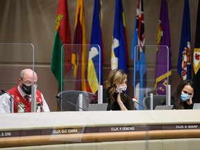 Councillors Peter Demong, left, Sonya Sharp, and Jasmine Mian during the last Calgary Council meeting before the Christmas break on Monday, December 20, 2021.