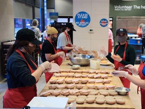 Volunteers prepare some of the thousands of lunches provided weekly by Brown Bagging for Calgary's Kids on Monday, November 15, 2021.