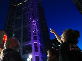 Calgarians watch 10-metre tall David, North America's largest marionette, make "The Ascent" – a climb of the 37-storey Devon Tower in Calgary. The event was part of this year's Beakerhead festival on Sept. 25, 2021. 
Gavin Young/Postmedia