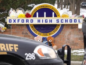Police keep watch outside of Oxford High School on December 01, 2021 in Oxford, Michigan. Yesterday, four students were killed and seven injured when a gunman opened fire on students at the school. A 15-year-old sophomore, believed to be the only gunman, is in custody.