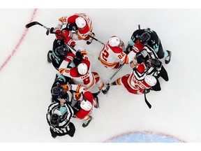The Calgary Flames and the Seattle Kraken shove each other during the first period at Climate Pledge Arena on Dec. 30, 2021, in Seattle, Wash.