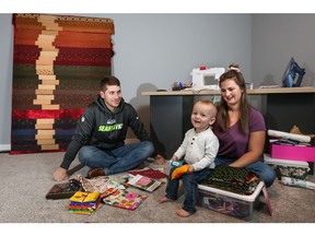 Lane and Morgan Wilson with their son Dawson Wilson, 19 months, in the loft of their new custom built home in the new Hillview neighbourhood in Strathmore.