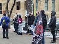 A group of about 20 protestors rallied outside Calgary City Hall to call for Ward 4 Coun. Sean Chu's resignation on Dec. 4, 2021.