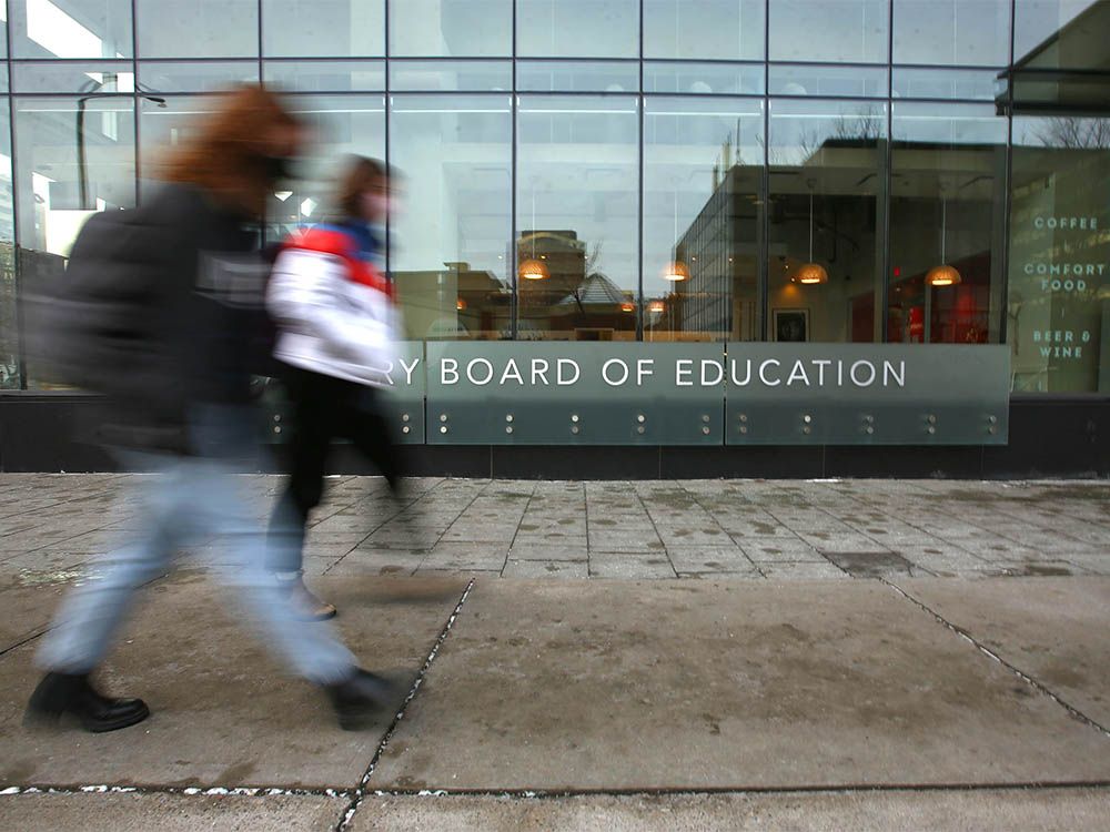  Pedestrians pass by the Calgary Board of Education building is shown In downtown Calgary on Tuesday, December 7, 2021.