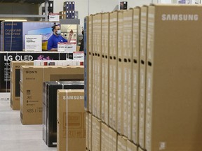 Sales associates line up electronic TV equipment at the Beacon Hill Best Buy store in Calgary on Sunday, December 26, 2021. Customers hit the store for Boxing Day deals.