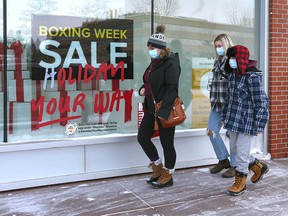 Customers brave the elements as they arrive at Market Mall in Calgary on Sunday, December 26, 2021. Customers hit the mall for Boxing Day deals.