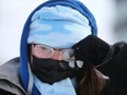 Teresa Dudley is bundled up and frosty as she walks near the University District in northwest Calgary on Sunday, December 26, 2021. Extrremely cold temperatures will be in the area for the rest of the week