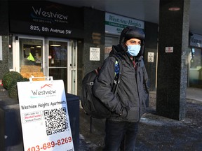 Jaimin Raval stands in front of the Westview apartments in downtown Calgary on Wednesday, December 29, 2021. He and a friend arrived from India three months ago, but are now out of their apartment due to flooding. They can’t access their apartment to gather items, but they do have insurance.
