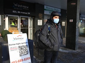 Jaimin Raval stands outside Westview Apartments in downtown Calgary on Wednesday, December 29, 2021. He and a friend arrived from India three months ago, but are now out of their apartment due to flooding. They cannot access their apartment to collect items, but they have insurance.