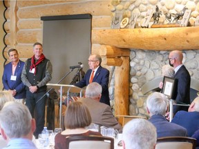 Businessman and philanthropist Dick Haskayne addresses attendees of a launch event for a new trail initiative, including project chair Alex Baum (far left) and Cochrane mayor Jeff Genung (far right). Patrick Gibson/Postmedia Network