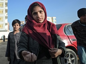 A girl begs on a street in Mazar-i-Sharif on December 24, 2021. Many women and girls in Afghanistan are in danger, simply because they are female.
