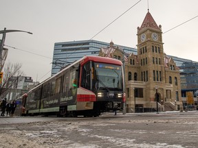 A CTrain passes City Hall in Calgary on Tuesday, December 7, 2021.