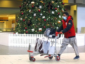 Travellers move through the Calgary International Airport on Tuesday, Dec. 14, 2021.