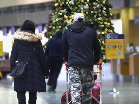 Air travellers during the Christmas rush at the Calgary International Airport in Calgary on Tuesday, December 14, 2021.