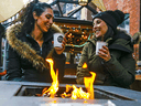 People get into the holiday spirit at the Christmas Market in Toronto's Distillery District.