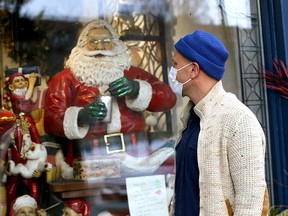 Erik Froese does some window shopping along 17th Avenue S.W. as COVID cases continue to rise in Calgary on Wednesday, Dec. 22, 2021.