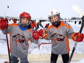 L-R, Ahmad Farad and Mirco Dufor from the Airdrie Storm were pumped to be playing hockey after being delayed a day due to cold weather during the third annual Tim Hortons Western Canada Pond Hockey Championships, which — with  over 50 teams participating — took place on the lake in Chestermere. The tournament runs from Dec. 28-30. Photo taken on Tuesday, December 28, 2021.