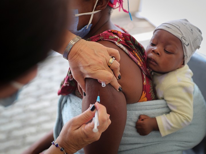  A health-care worker administers a COVID-19 vaccine to a woman in Johannesburg, South Africa, on Dec. 4, 2021.