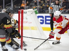 The Calgary Flames’ Johnny Gaudreau takes a shot on goal while the Vegas Golden Knights’ defends at T-Mobile Arena in Las Vegas on Sunday, Dec. 5, 2021.