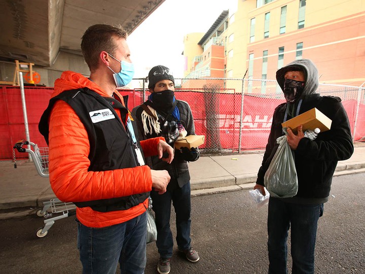  Scott While, a worker with the Aboriginal Friendship Centre, delivers food to residents.