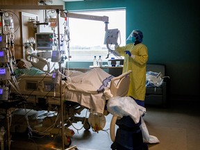 A nurse tends to a COVID-19 patient in the intensive care unit of Humber River Hospital in Toronto on April 15, 2021.