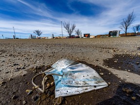 A discarded face mask is seen in a parking lot in northeast Calgary during the early days of the pandemic in 2020.
