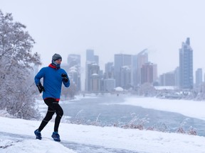 A jogger braves the cold to go for an afternoon run along the Bow River pathway on Monday, January 3, 2022.