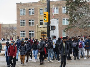Students at Western Canada High School exit the school for their lunch break on their first day of being back in classes in the new year on Monday, January 10, 2022.