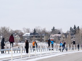 A group of students go for a walk along the pathway at Crescent Heights on a cold afternoon on Tuesday, January 18, 2022.