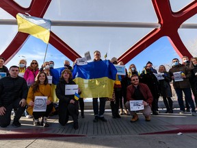 Participants in a rally organized by Calgary's Ukrainian Canadian Congress show solidarity with the Ukrainian people on the Peace Bridge on Saturday, January 22, 2022.