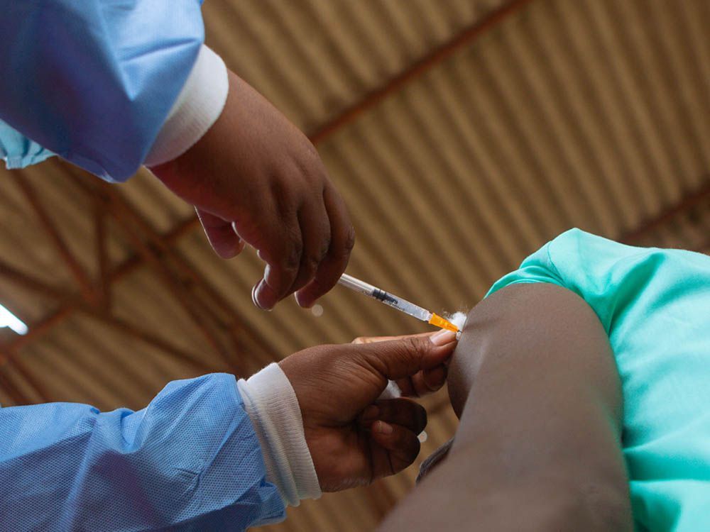  A teenager gets his first jab of the COVID-19 vaccine on Dec. 15, 2021, in Chinhoyi, Zimbabwe.