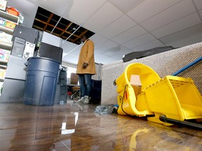 Gar Gar, a community member and volunteer looks at flood damage inside the Forest Lawn Community Association in southeast Calgary on  Sunday, January 9, 2022.