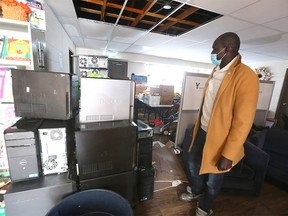 Gar Gar, community member and volunteer, examines flood damage inside the Forest Lawn Community Association in southeast Calgary on Sunday, January 9, 2022.