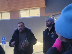 Artur and Dawid Pawlowski speak to a group of supporters outside the Calgary police's arrest processing facility after their release on Jan. 2, 2021.