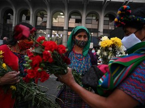 Guatemalan Achi women, victims of sexual violence during the internal armed conflict (1960-1996), react at the end of the trial against five former Guatemalan Civil Patrol (PAC) members, outside the Justice Palace in Guatemala on January 24, 2022. - Five former Guatemalan paramilitaries were sentenced Monday by a court to 30 years in prison for sexual violence committed against indigenous women in the municipality of Rabinal in the 1980s during the civil war (1960-1996).