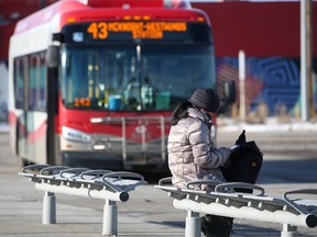 A transit user waits for a bus at the Chinook CTrain station on Jan. 16, 2022.