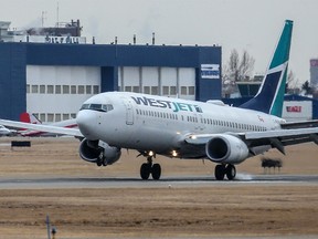 WestJet flight 210 from Vancouver lands at the Calgary International Airport on Tuesday, January 18, 2022. WestJet announced it would be consolidating or cancelling up to 20 per cent of its flights through Feb. 28.