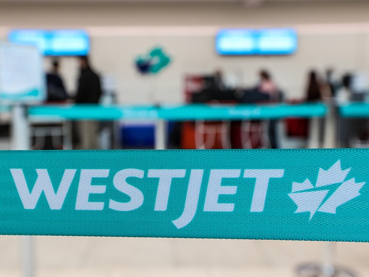  A WestJet check-in area at the Calgary International Airport was photographed on Tuesday, January 18, 2022. WestJet announced it would be consolidating or cancelling up to 20 per cent of its flights through Feb. 28.