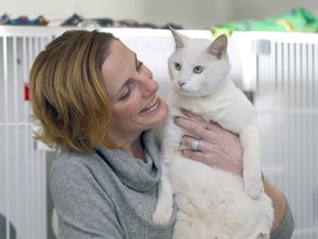 Carrie Fritz, executive director of the Calgary Humane Society, snuggles (Betty) White — a 5-year-old male cat put up for adoption on Betty’s 100th birthday as donations were pouring in to the Humane Society in Calgary on Monday, January 17, 2022.