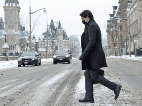 Prime Minister Justin Trudeau walks back to his office on Parliament Hill after a news conference on the COVID-19 situation on January 12, 2022 in Ottawa.