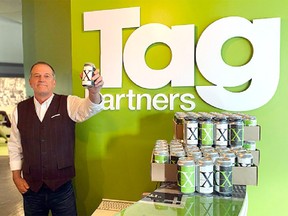 Todd Sloane, owner and creative lead of Tag Advertising, with his Canmore brewed XXX beer, celebrating 30 years in business.