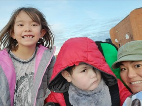 Emiko (6), Ryan (8) and mother Fuyo Watanabe (R) are shown in a recent family photo. Her son has very high needs, with severe allergies. Their doctor says he needs a HEPA filter in the classroom.