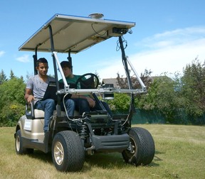 Alex Rodrigues, left, with the self-driving golf cart he built with Brandon Moak and Michael Skupien.