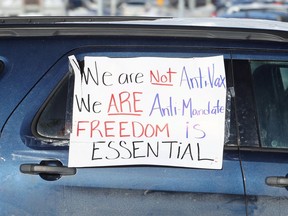 A sign on a van as a portion of the Freedom Convoy stopped outside the Manitoba Legislative Building in Winnipeg on Mon., Jan. 24, 2022