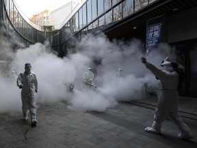 Health workers spray disinfectant outside a shopping mall in Xi’an, Shaanxi, China on Jan. 11.