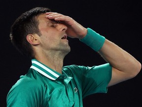 (FILES) This file photo taken on February 16, 2021 shows Serbia's Novak Djokovic reacting after losing a point against Germany's Alexander Zverev during their men's singles quarter-final match on day nine of the Australian Open tennis tournament in Melbourne. - Australia's government cancelled Novak Djokovic's visa for a second time on January 14, 2022 as it sought to deport the superstar over his Covid-19 vaccine status. (Photo by Brandon MALONE / AFP) / -- IMAGE RESTRICTED TO EDITORIAL USE - STRICTLY NO COMMERCIAL USE --