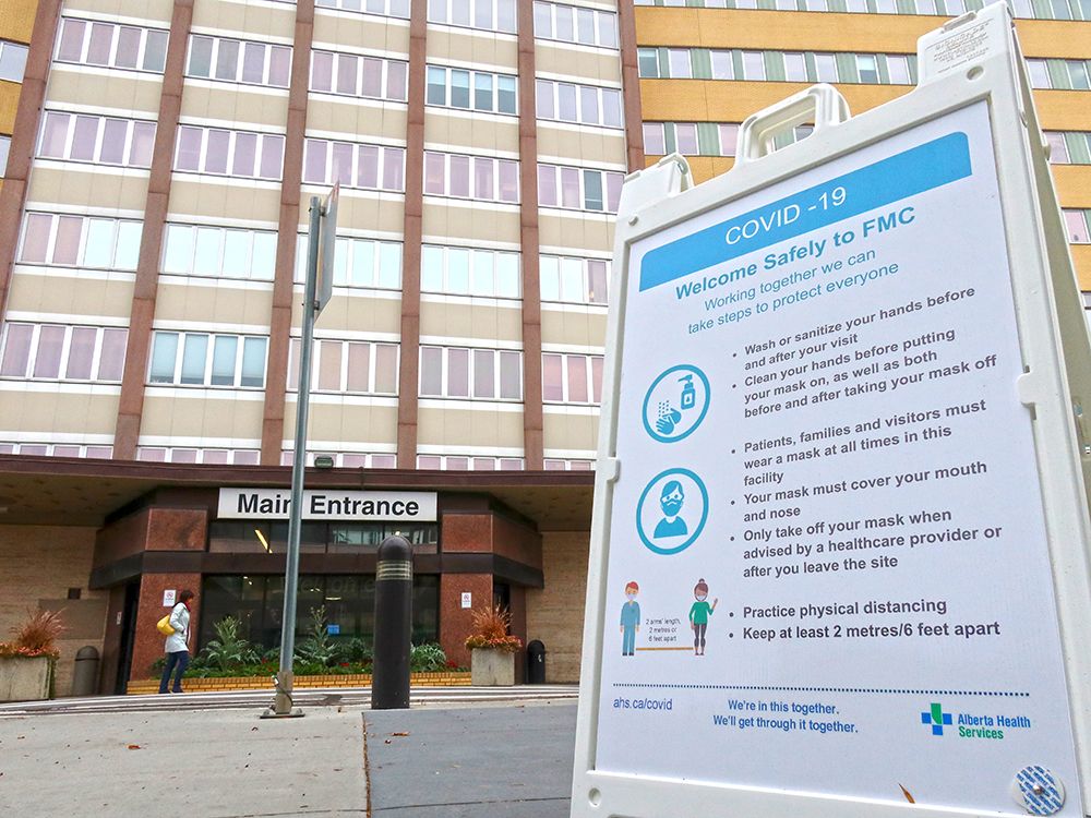 A COVID-19 information sign is seen outside the Foothills Hospital in Calgary on Oct. 13, 2020. 