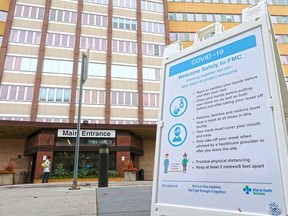 A COVID-19 information sign is seen outside the Foothills hospital in Calgary on Oct. 13, 2020.