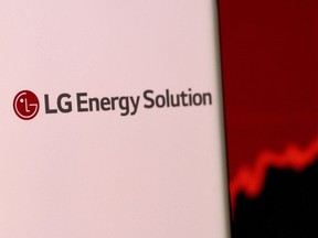 FILE PHOTO: LG Energy Solution's logo is pictured on a smartphone in front of a stock graph displayed in this illustration taken, Dec. 4, 2021. REUTERS/Dado Ruvic/Illustration/File Photo