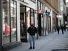 People walk along Ste-Catherine street in Montreal, next to closed stores, during a lockdown on Dec. 29, 2020.